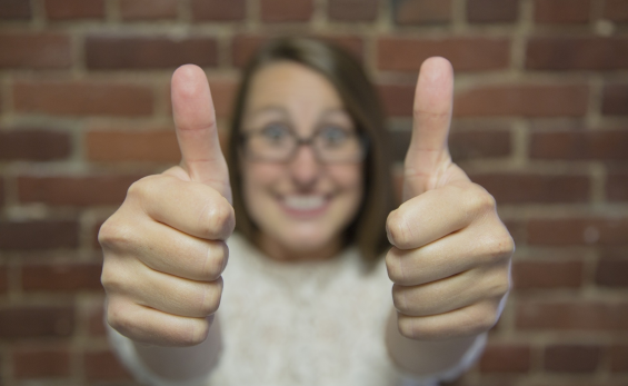 Image of a happy lady giving the thumbs up to her new custom application