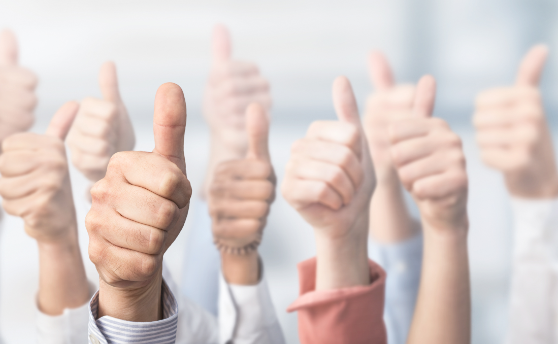 A group of people with their thumbs up as they are happy that they chose tailor-made software for their business